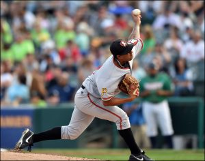 baseball player throwing a pitch